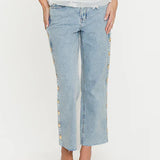Light blue jeans with floral embroidery on a white background