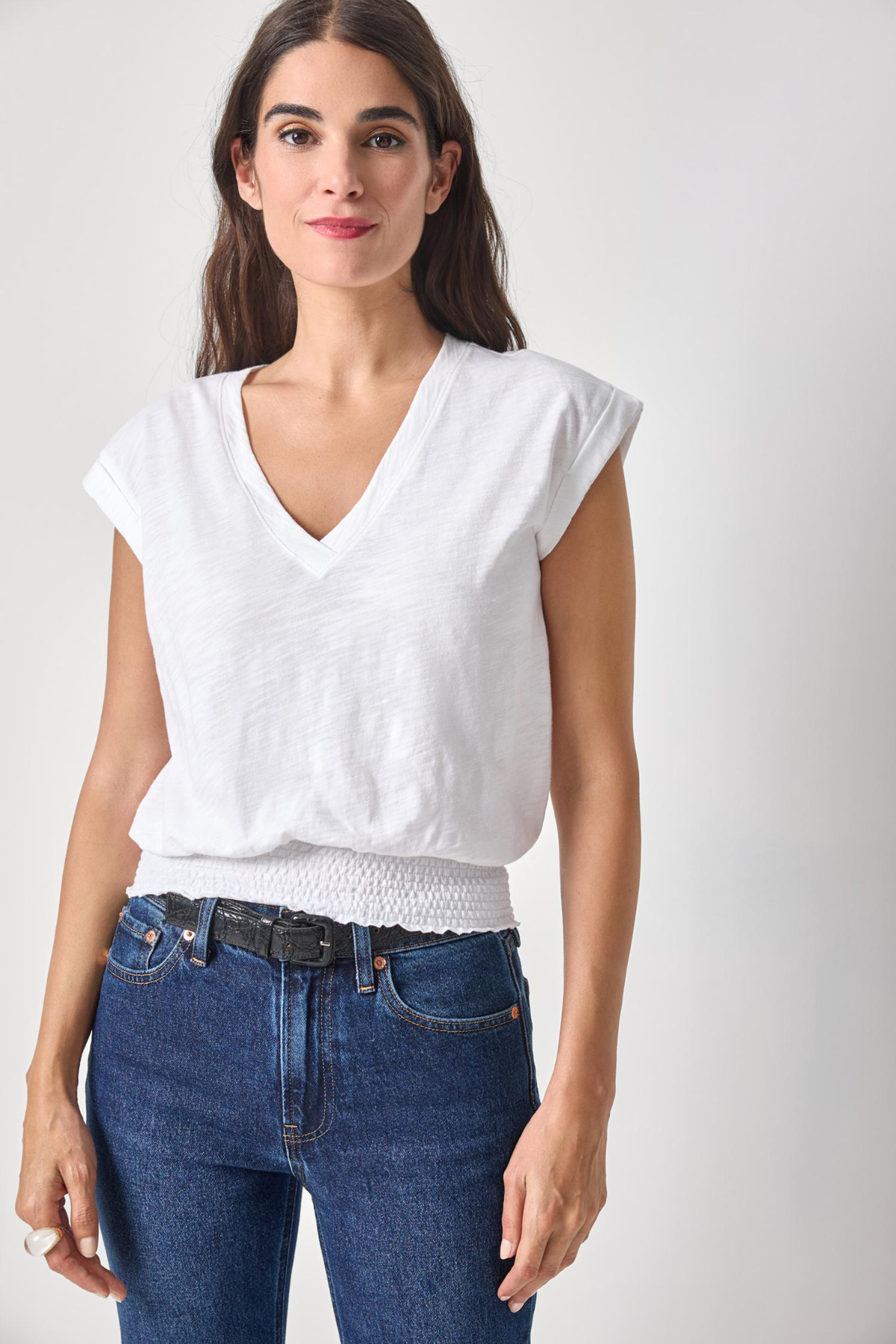 woman in white vneck tee on white background 