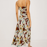 Woman wearing a floral brown pattern dress on a white background