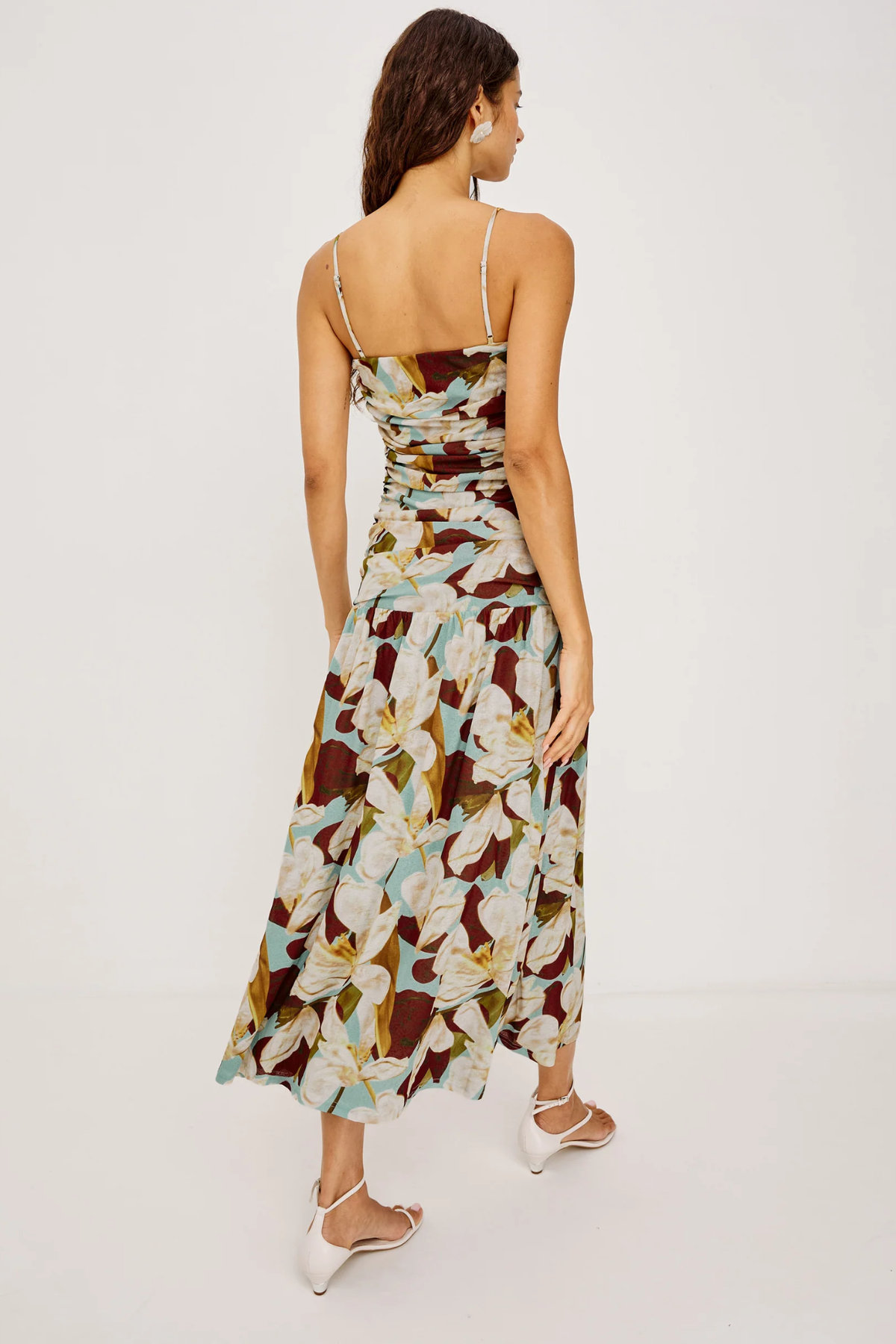 Woman wearing a floral brown pattern dress on a white background