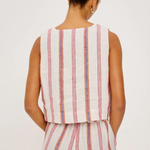 Person wearing a sleeveless striped top and pants on a white background