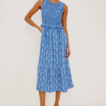 blue smocked printed dress on woman on white background 