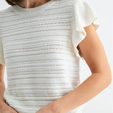 White textured top worn by a person on a white background