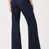 Navy blue pants worn by a person on a white background