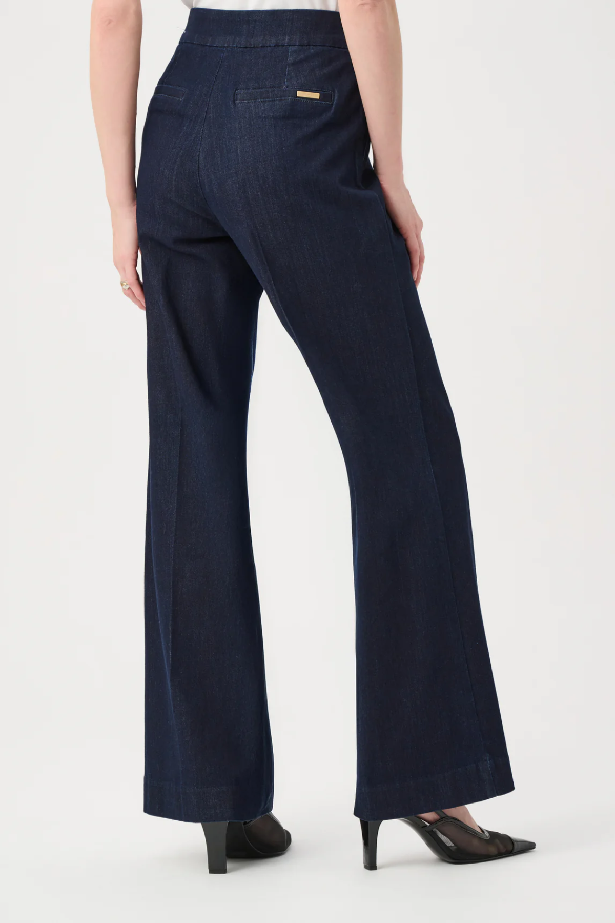 Navy blue pants worn by a person on a white background