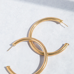 Gold hoop earrings on a white background