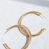 Gold hoop earrings on a white background