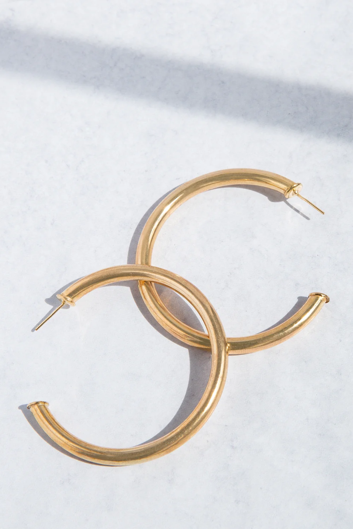 Gold hoop earrings on a white background