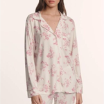 Woman wearing a floral pajama set on a white background