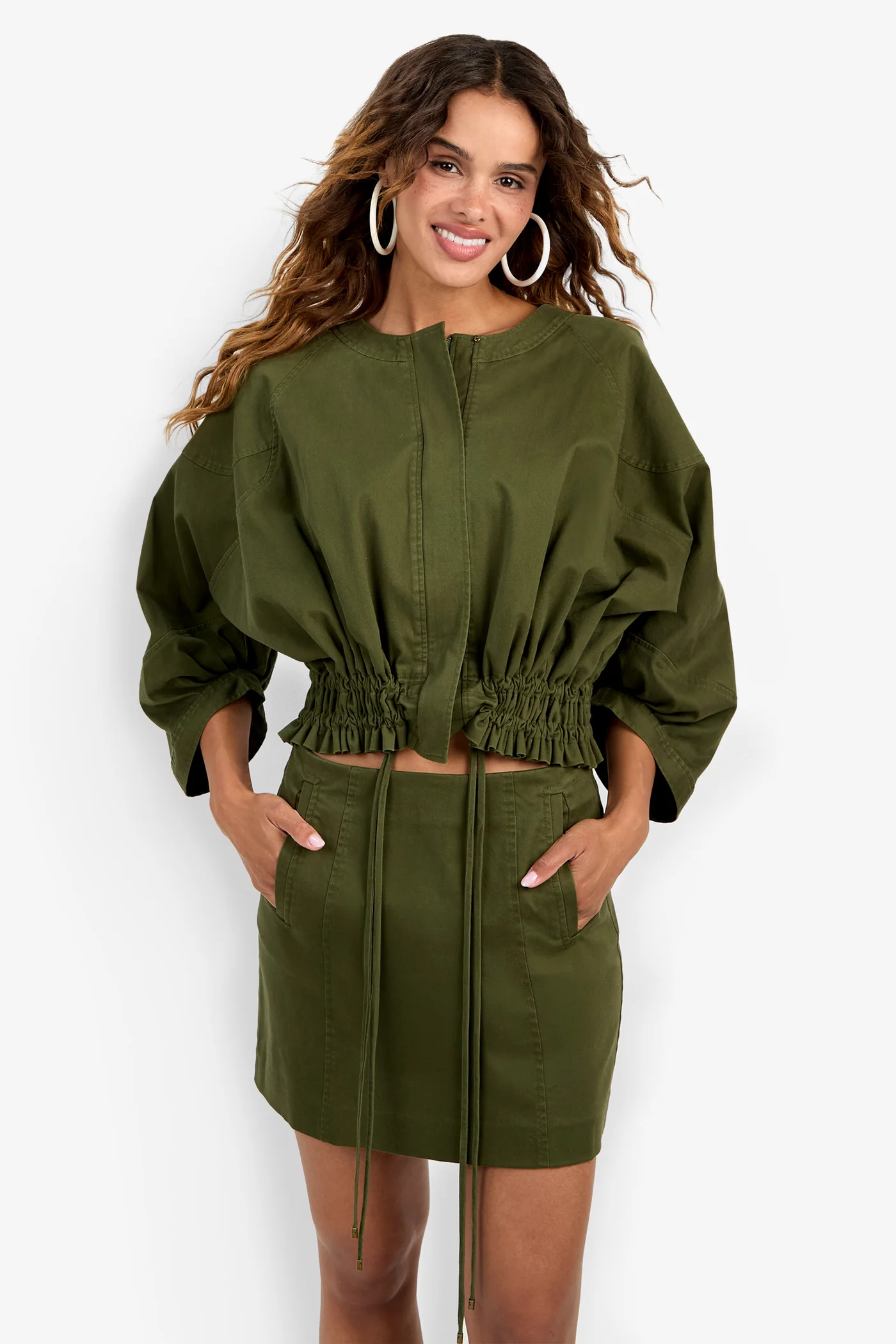 Model wearing a structured jacket with long sleeves and a flattering tailored silhouette.