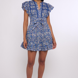 Model wearing a blue printed mini dress with short sleeves and a fitted waist.