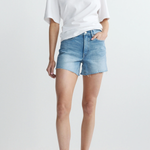 Person wearing a white t-shirt and denim shorts on a plain background