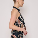 Model wearing a sleeveless printed halter top with a coordinating floral-inspired pattern and relaxed silhouette.