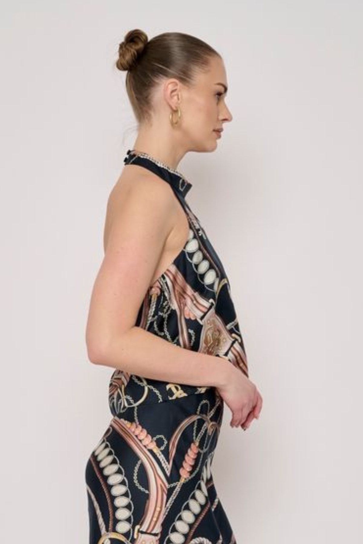 Model wearing a sleeveless printed halter top with a coordinating floral-inspired pattern and relaxed silhouette.