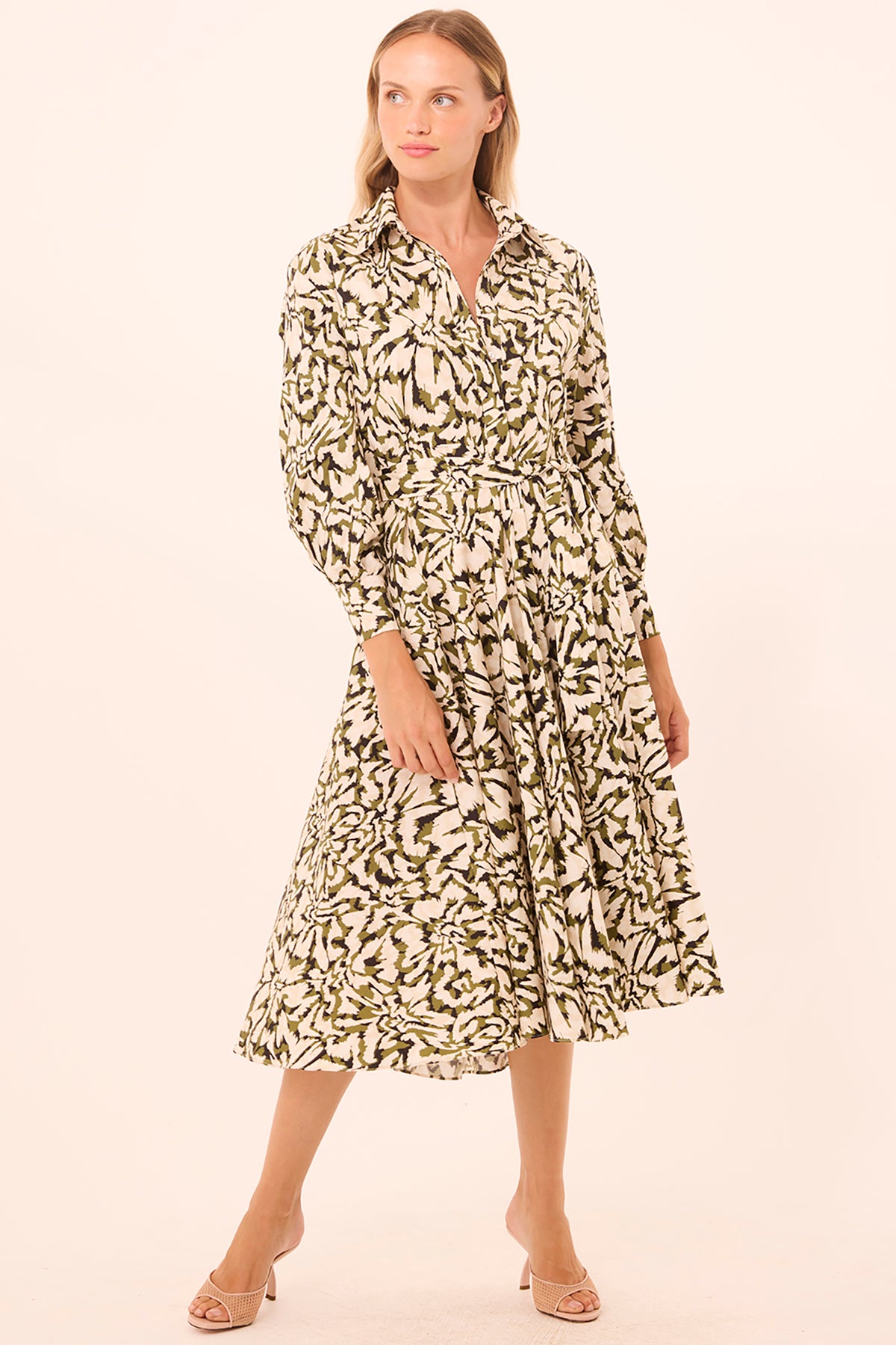 Woman wearing a patterned dress on a beige background