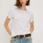 Person wearing a white t-shirt and blue jeans with a brown belt on a plain background