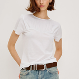 Person wearing a white t-shirt and blue jeans with a brown belt on a plain background