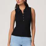 Woman wearing a black sleeveless ribbed polo shirt and light blue jeans on a plain background