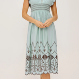 Light blue dress with lace details on a white background