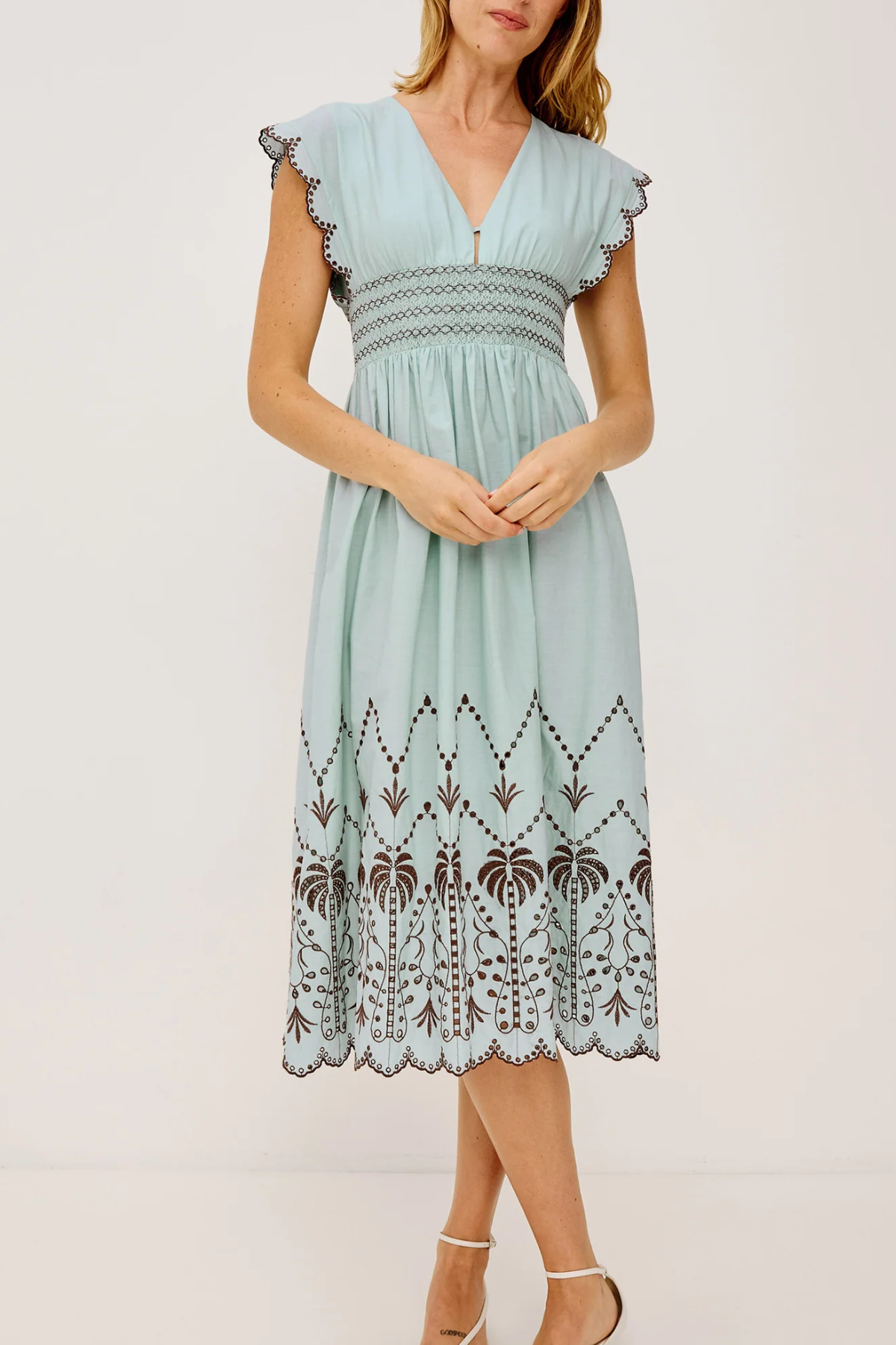 Light blue dress with lace details on a white background