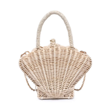 Wicker handbag shaped like a shell on a white background