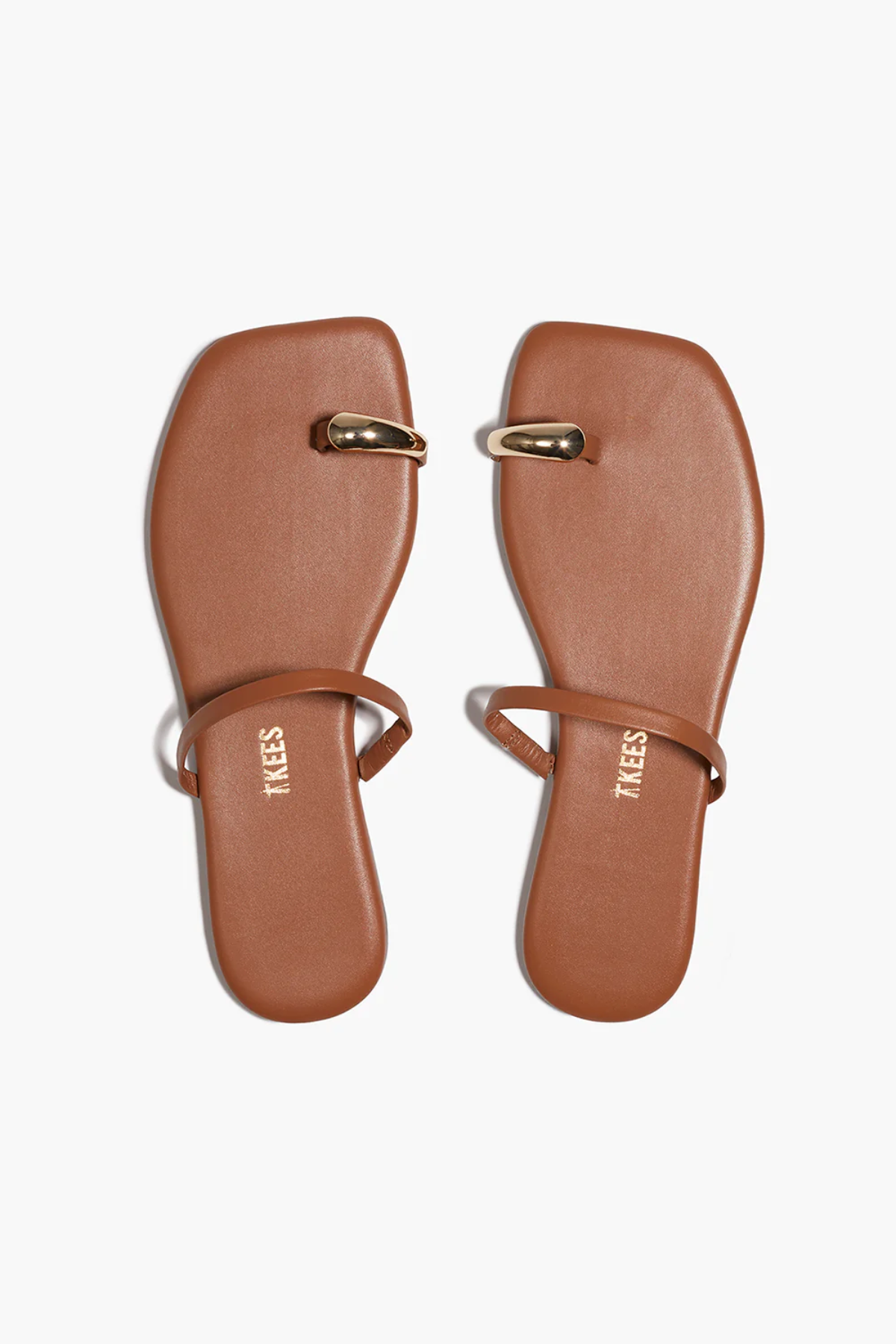 Pair of brown sandals with gold accents on a white background
