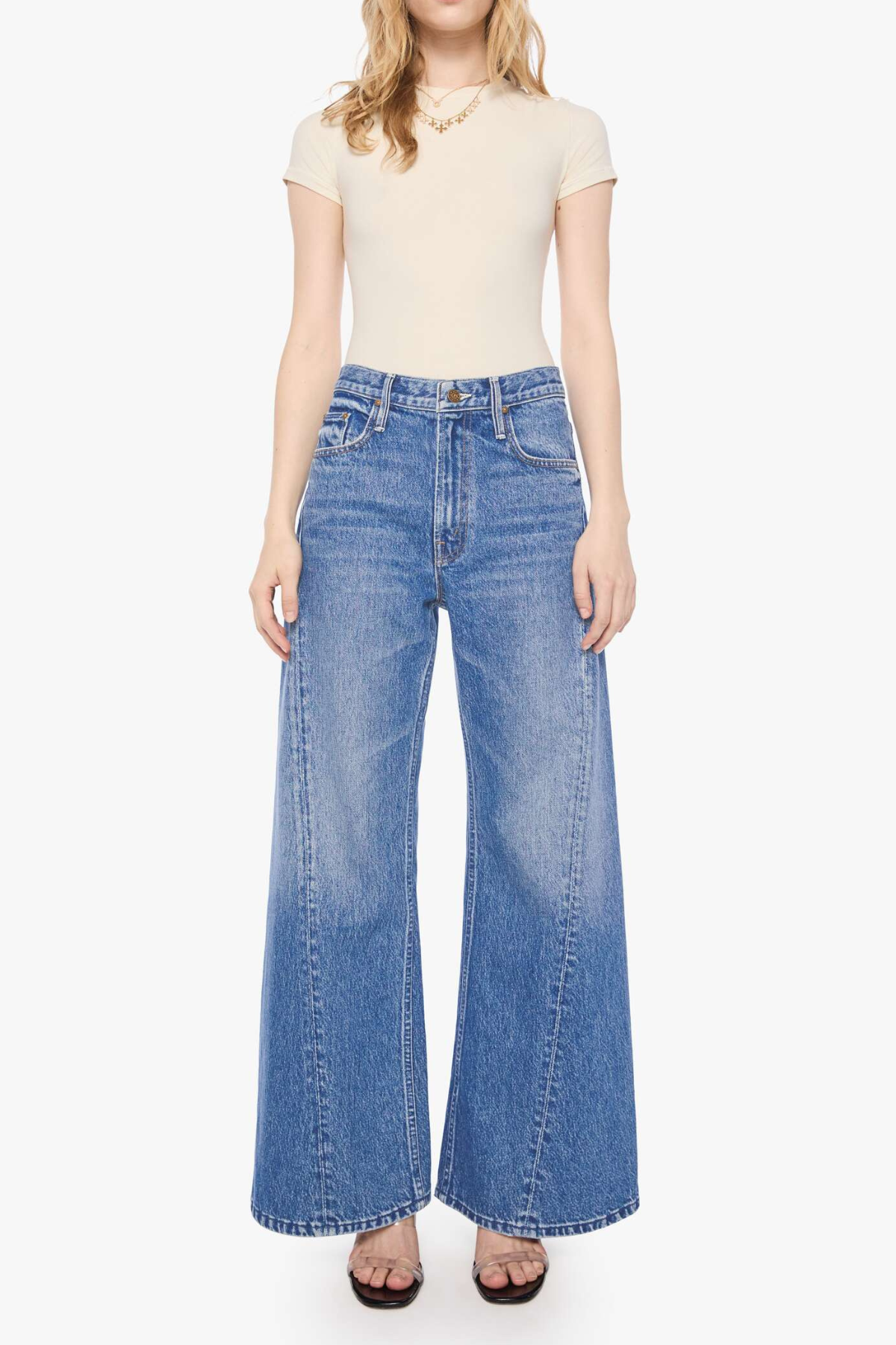 Model wearing light-wash straight-leg denim jeans with a cropped ankle-length silhouette.