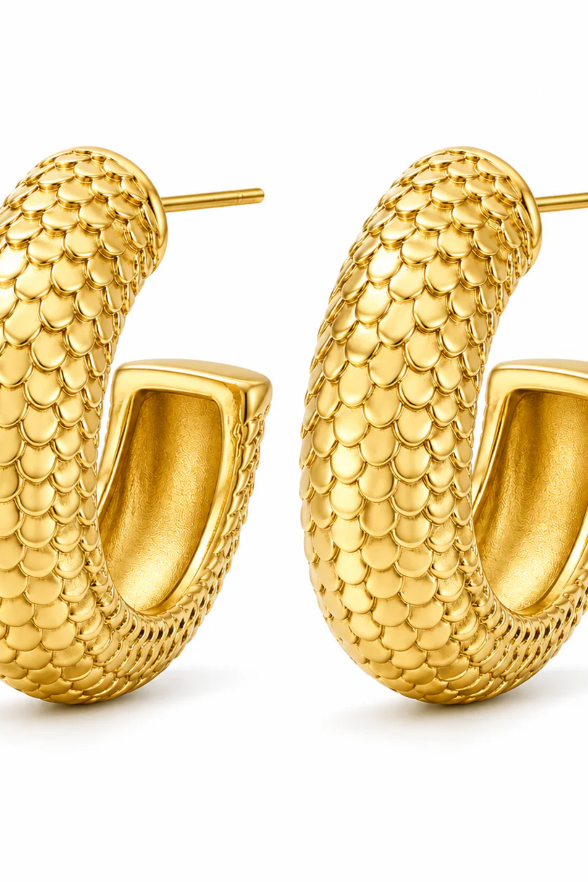 Gold hoop earrings with a textured pattern on a white background