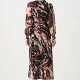 Woman wearing a long, patterned dress on a white background