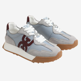 A pair of low-top sneakers in light gray suede and synthetic materials, featuring white laces, a white midsole, a brown gum outsole, and a dark brown 'GG' logo on the side.