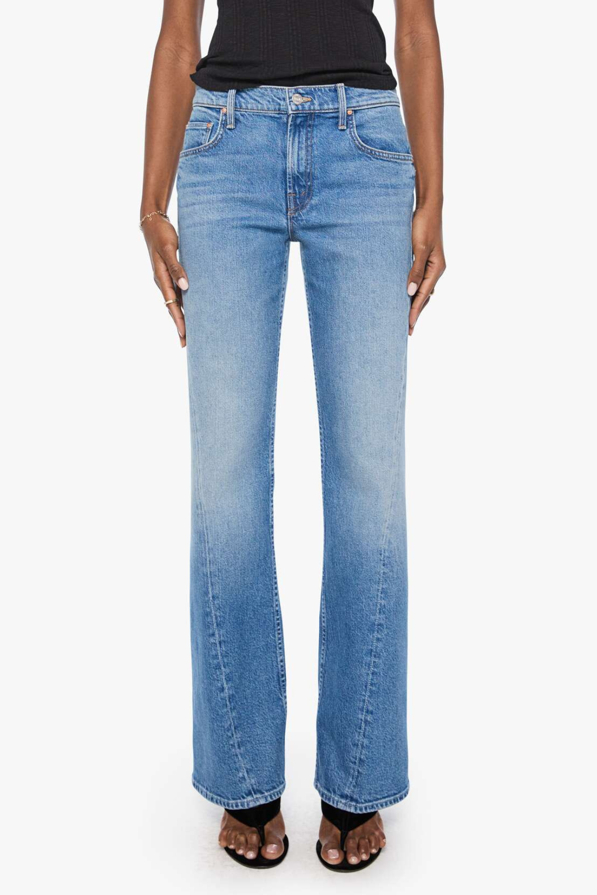 Model wearing light-wash denim jeans with twisted seam detailing and a relaxed straight-leg fit.