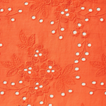close up of orange eyelet fabric 