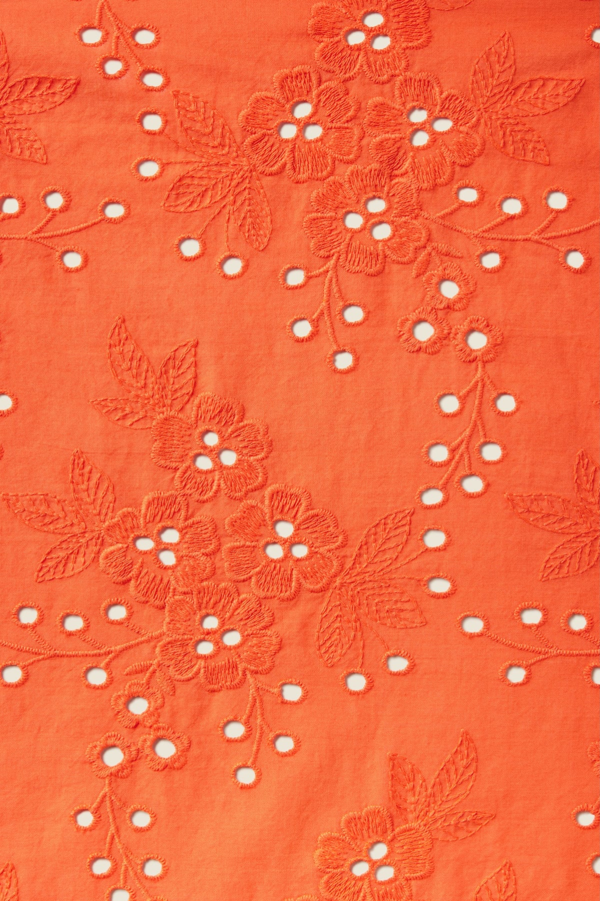 close up of orange eyelet fabric 