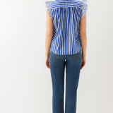 back of woman in jeans and stripe ruffle top
