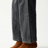 Women's brown textured ankle boot featuring a sleek silhouette and heel.