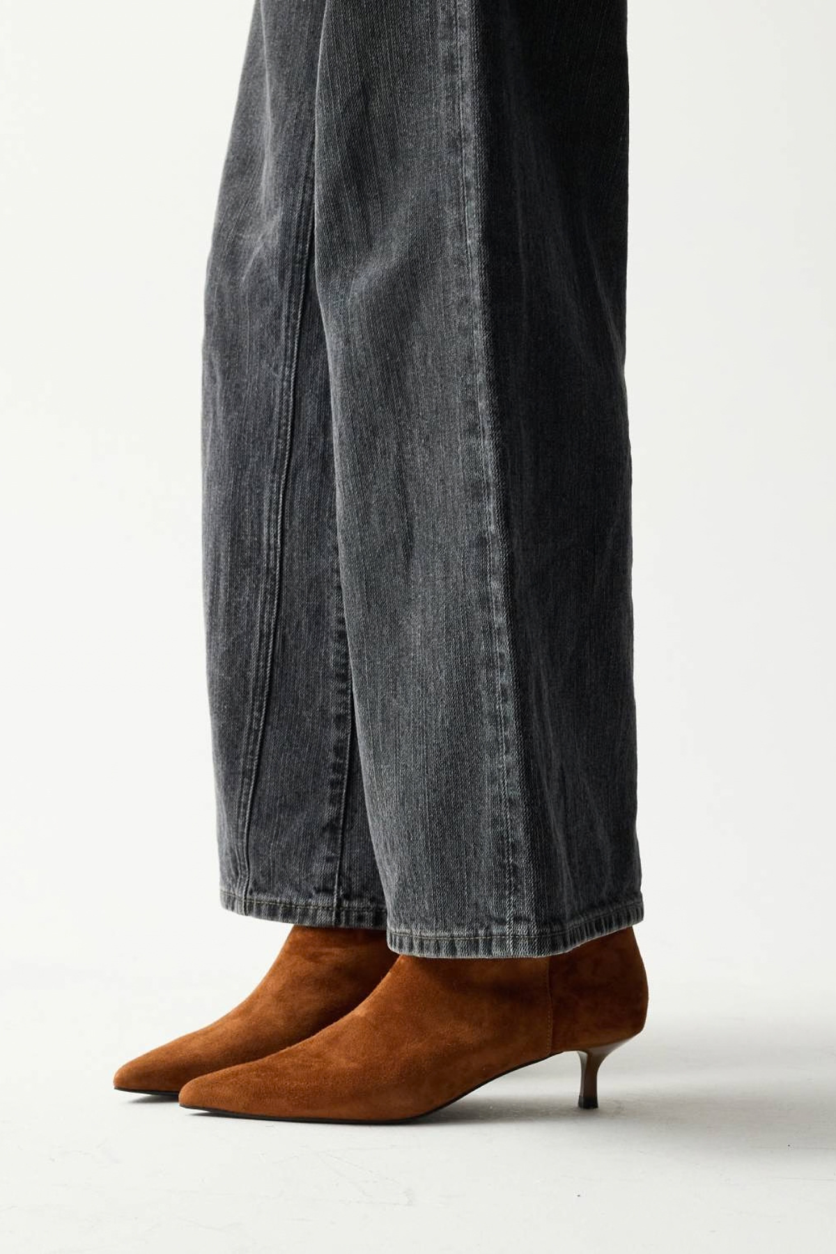 Women's brown textured ankle boot featuring a sleek silhouette and heel.