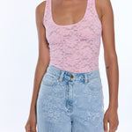 woman in pink lace tank top on white background 