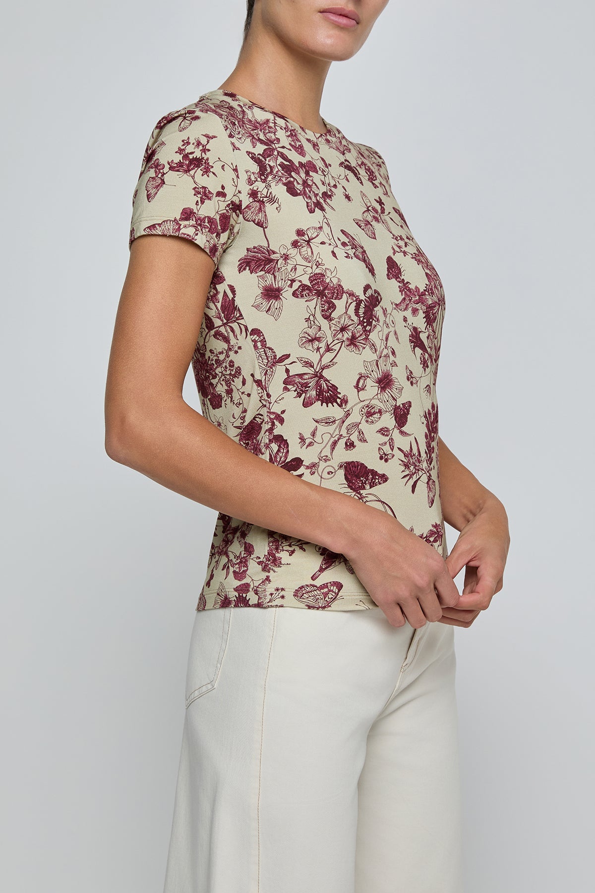 Person wearing a floral-patterned shirt with a plain background