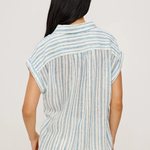 Woman wearing a striped shirt with a plain background