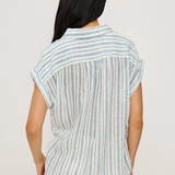 Woman wearing a striped shirt with a plain background