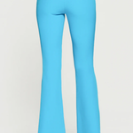 Turquoise pants worn by a person on a white background