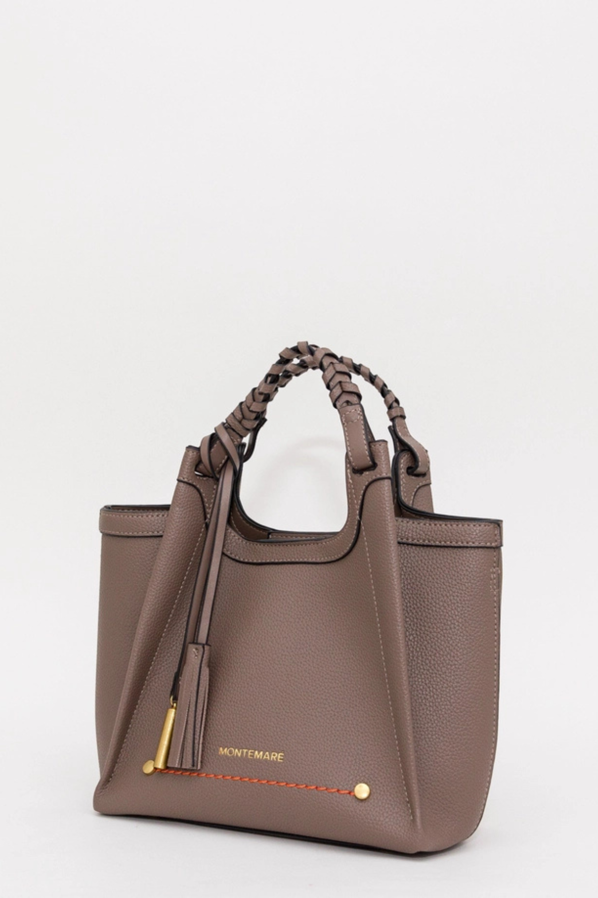 A taupe brown pebbled leather handbag with braided top handles, a tassel detail, and gold hardware, shown on a plain light gray background.