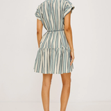 Woman wearing a striped dress on a white background