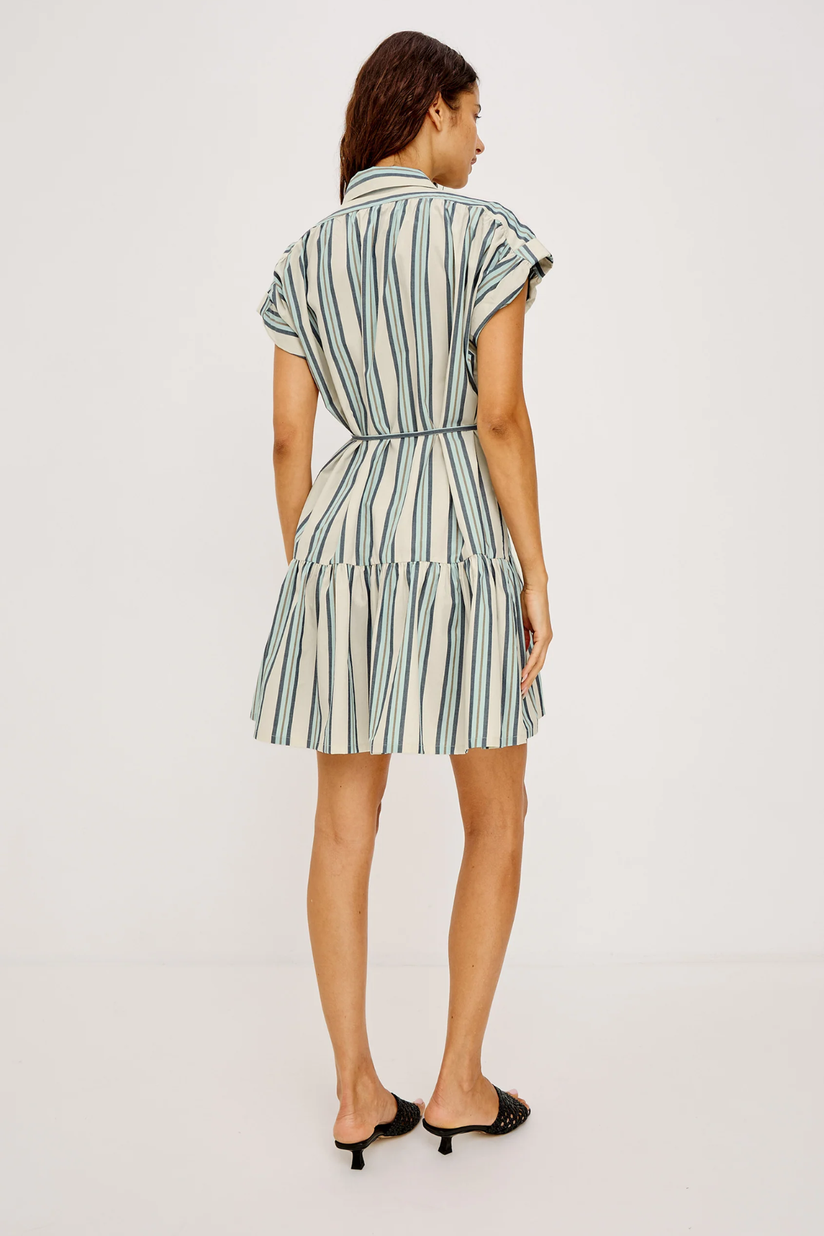 Woman wearing a striped dress on a white background