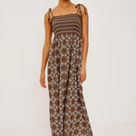 Woman wearing a patterned dress on a white background