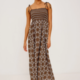Woman wearing a patterned dress on a white background