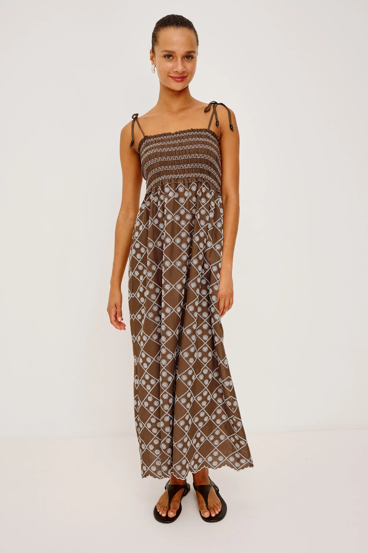 Woman wearing a patterned dress on a white background