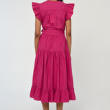 Woman wearing a vibrant pink sleeveless midi dress with soft tailoring and fluid drape.