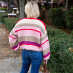 Striped knit cardigan worn open over a simple top