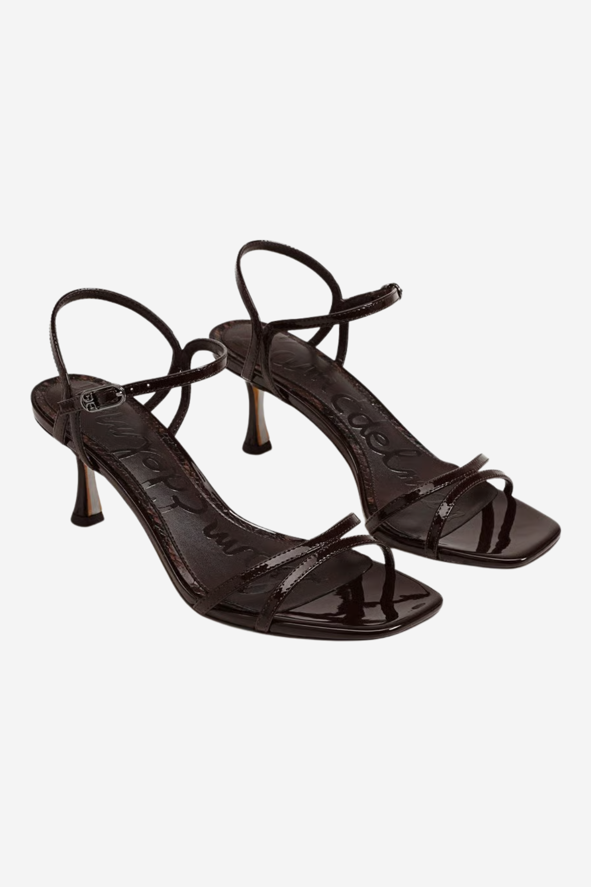 A pair of glossy black strappy high-heeled sandals with square toes and thin ankle straps, shown on a light gray background.